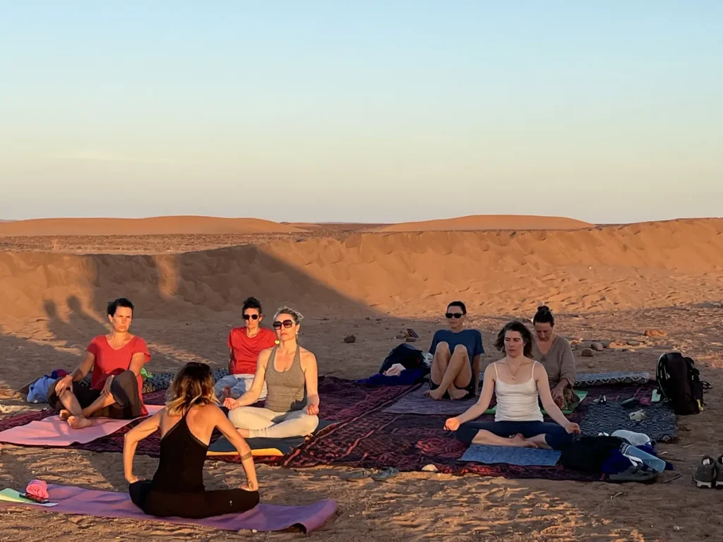 Moment pause yoga et pranayama dans le désert marocain, stage yoga et sagesse animale avec Sophie Ancel